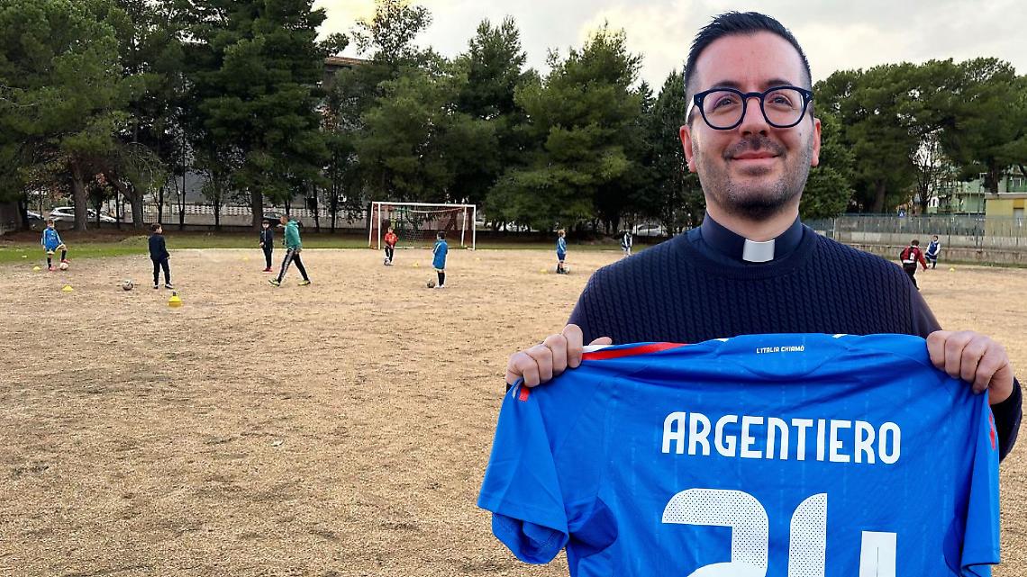 Don Alessandro Argentiero, parroco della chiesa Ss. Angeli Custodi. Sullo sfondo il campo sportivo oggetto dello stanziamento della Regione Puglia
